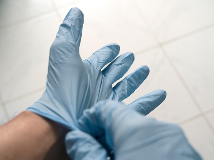 Hände in OP-Handschuhen